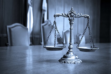 Scales of justice on the conference room table of a Virginia U.S. Federal Government Suspension and Debarment Attorney