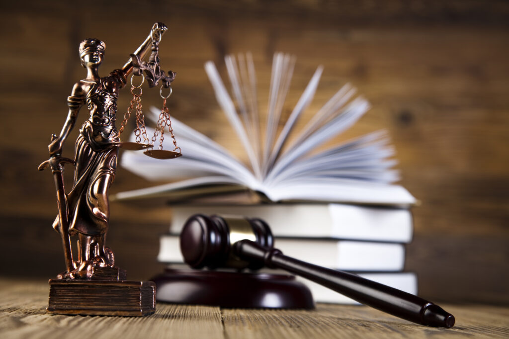 Lady justice statue, gavel, and law books belonging to a DC Security Clearance Lawyer
